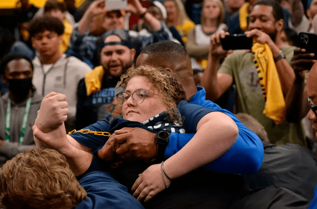 Animal rights activist is removed during a protest at a basketball game.